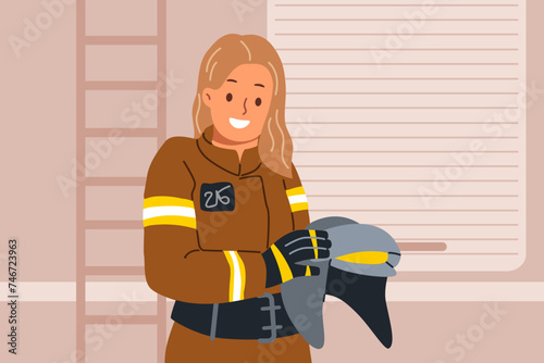 Woman firefighter holds helmet in hands, standing near rescue van and preparing to go out to extinguish fire. Young girl firefighter smiles and looks at camera, getting to fight flames