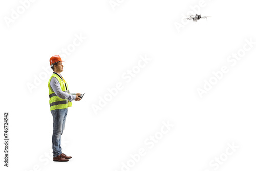 Engineer in a safety vest flying a drone with a remote controller