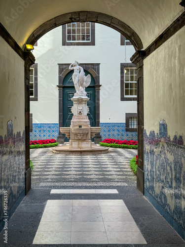 Courtyard view with majestic sculpture in city hall Paços do Concelho in city centre of Funchal, Madeira island, Portugal, Europe. Marble statue of Leda and the Swan. Tourist destination. photo