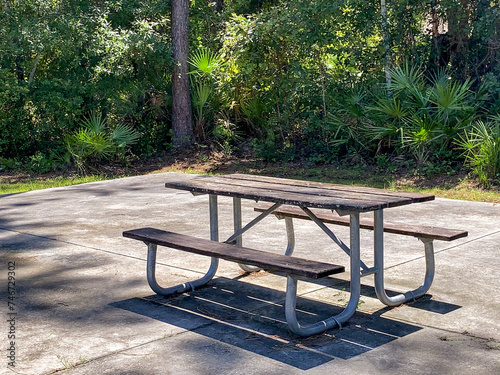 Picnic table on a cement slab in a park