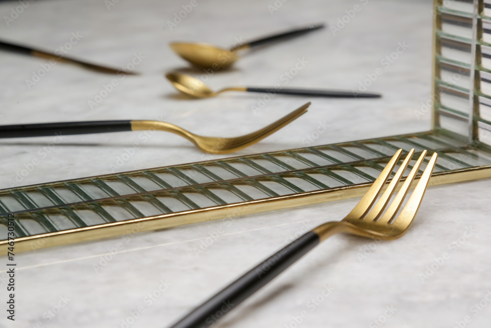 Creative shot of golden cutlery on marble table, Design concept. Modern kitchen. Scandinavian style tableware. Creative shot of golden cutlery on marble table, Design concept. Modern kitchen. Scandinavian style tableware.