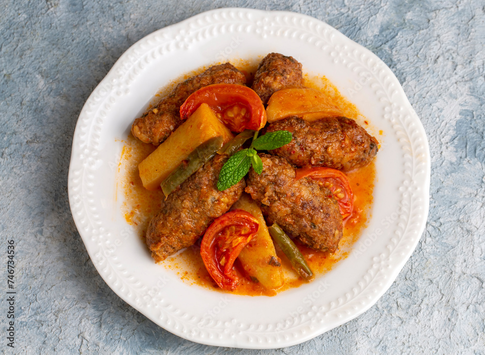 Traditional Homemade Turkish Food Kofte - Kofta with Tomato Sauce and Potatoes. (Turkish name; Izmir kofte) Traditional Homemade Turkish Food Kofte - Kofta with Tomato Sauce and Potatoes. (Turkish name; Izmir kofte)