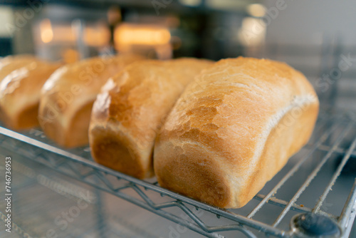 close-up of freshly baked warm bread on an iron rack in professional kitchen