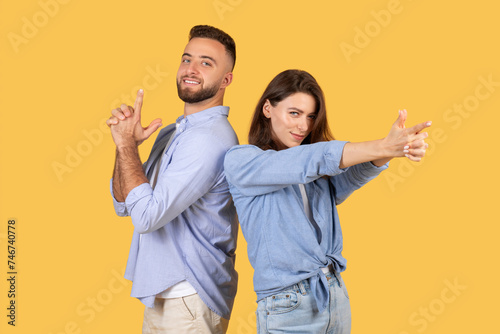 Fun couple back-to-back with finger guns