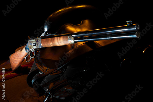 Orange rim light on the lever action carbine and saddle photo