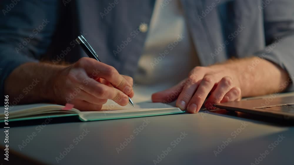 Man hands writing notebook at late office closeup. Anonymous guy making notes Man hands writing notebook at late office closeup. Anonymous guy making notes
