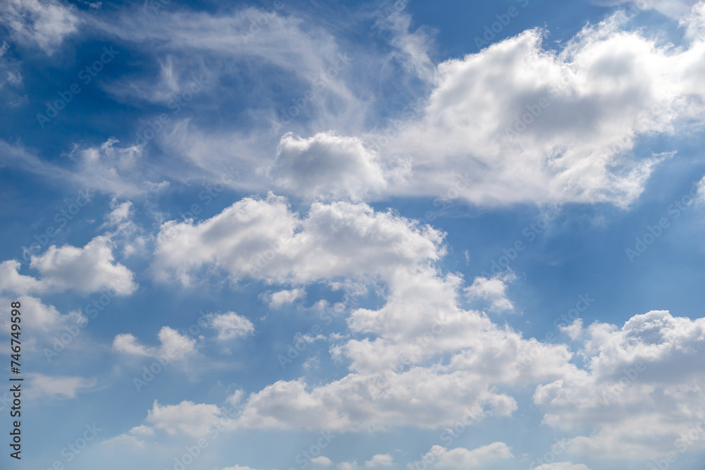 Blue sky with puffy cloud formations, natural background Blue sky with puffy cloud formations, natural background