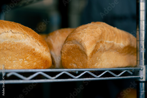 close-up of freshly baked square bread on racks in professional kitchen
