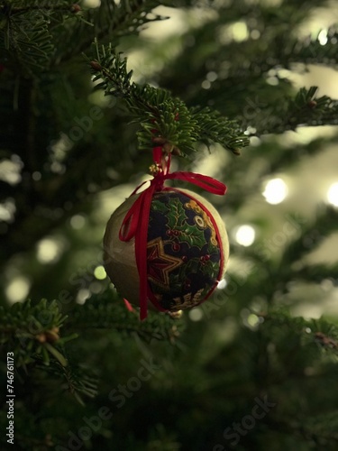 Christmas tree decorated with baubles, lights, gingerbread and candies.
