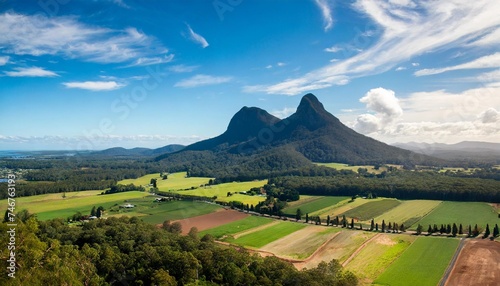 glass house mountains sunshine coast queensland australia showing blue sky mountains paddocks farming land and forests photo