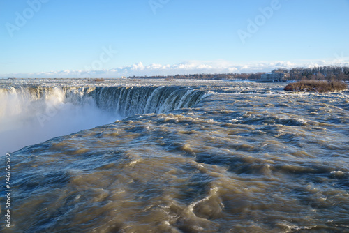 Niagara waterfalls in Canada. The mighty falls is flowing hard when being frozen. The Canada ends has greater looks where the start at its horseshoe. This natural wonder is beautiful in all seasons © Minty