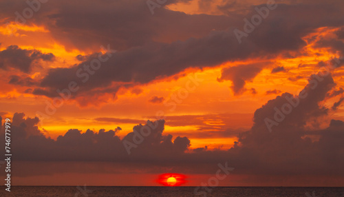 Coastal landscape with dramatic red sky over the ocean on a sunset