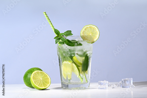 Glass with mojito cocktail and limes