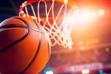 Close-up of a basketball going into the hoop during a game.