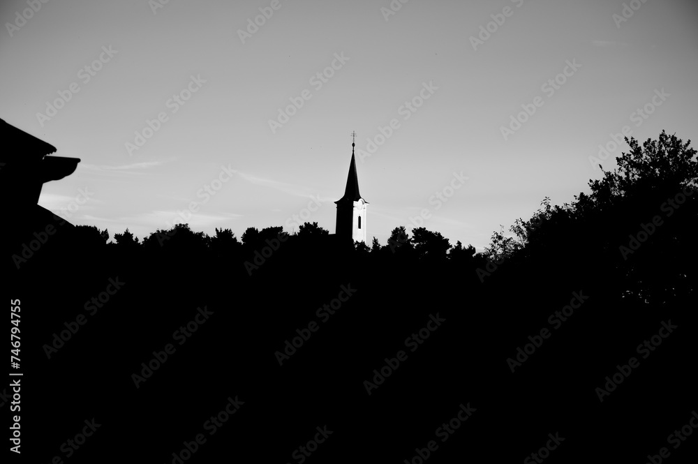 Obraz premium Black and white background with silhouettes of tower on sky.