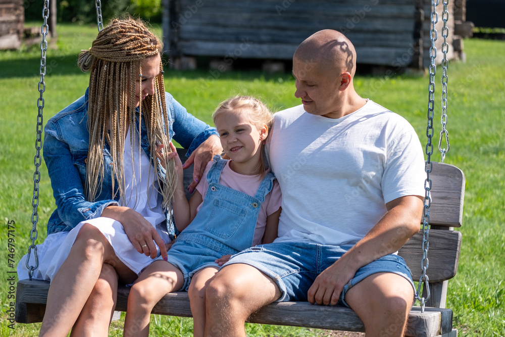 A family of three shares a joyous moment on a swing, highlighting the essence of healthy living and the importance of quality family time. A family of three shares a joyous moment on a swing, highlighting the essence of healthy living and the importance of quality family time.