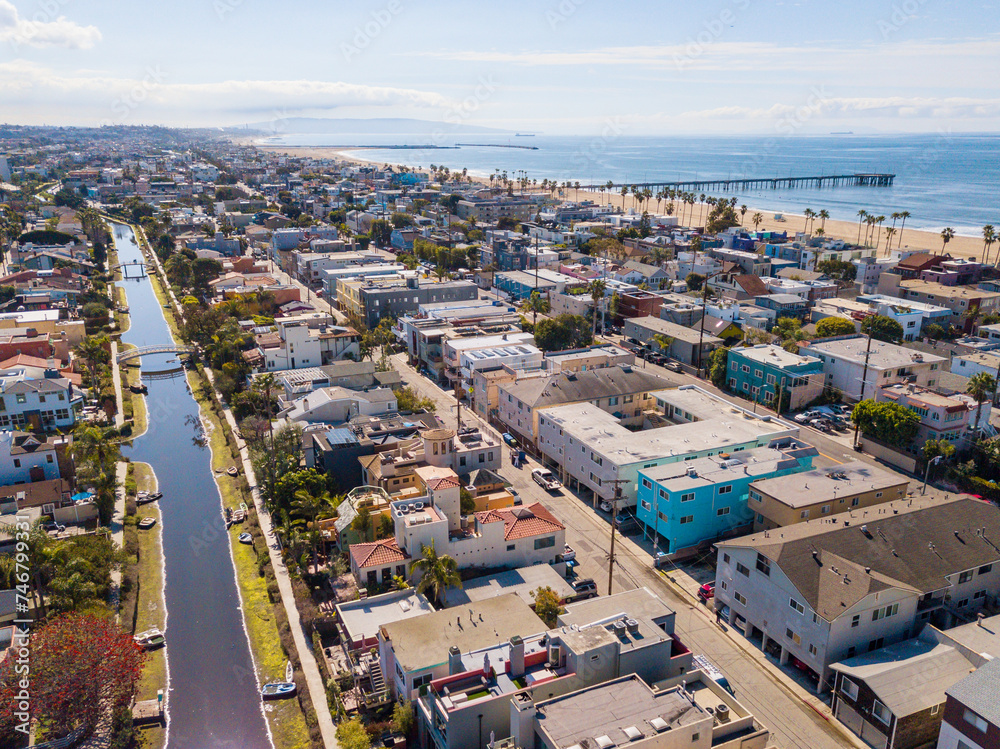 Aerial drone view over Venice Canals Historic District  looking south down the Grand Canal with the beach and Venice Pier.