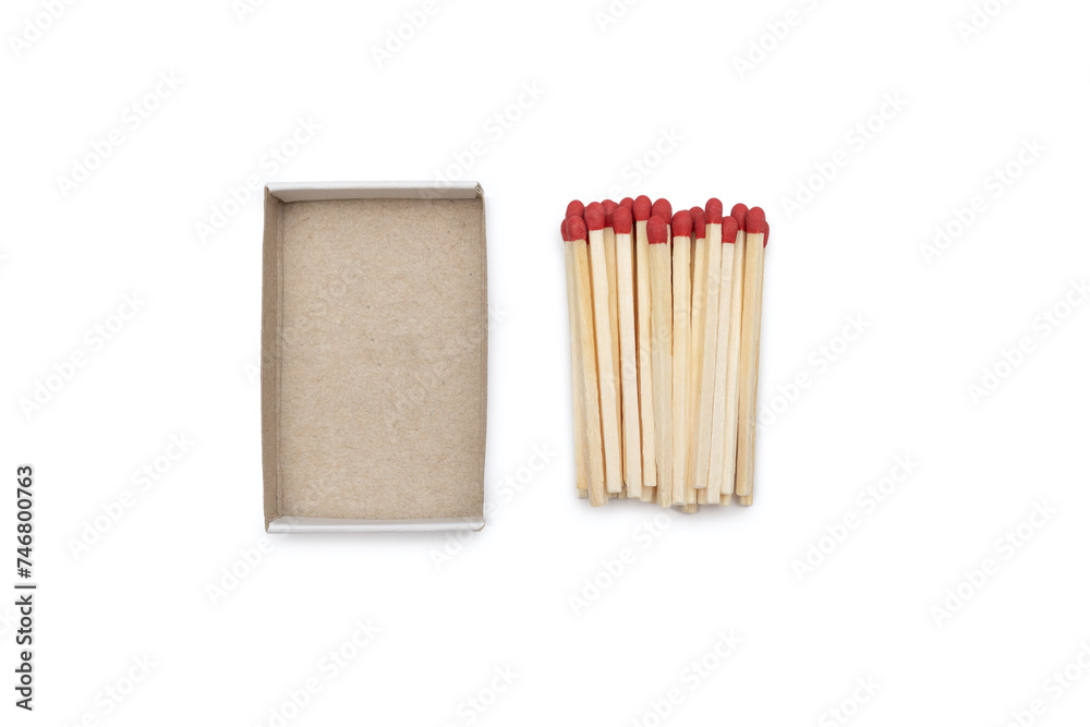 Matches near an empty cardboard matchbox isolated on a white background. Matches with a red head and empty open matchbox close-up Matches near an empty cardboard matchbox isolated on a white background. Matches with a red head and empty open matchbox close-up
