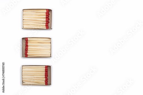 Three open matchboxes filled with matches are horizontally arranged on a white background. Top view of matches close-up with space for text. Matchboxes with matches isolated on white background