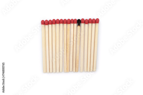 A row of red matches and one burnt match among them on a white background. Matches without a matchbox and a burnt match in the center of a close-up photo with space for text