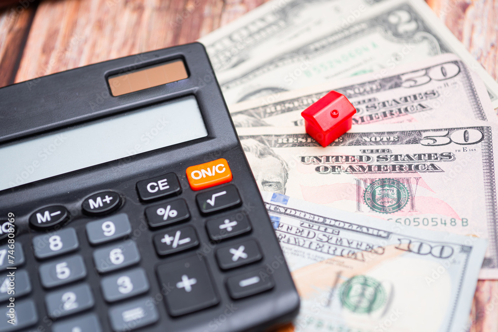 Housing market in the United States. Calculator next to keys and American dollars Housing market in the United States. Calculator next to keys and American dollars