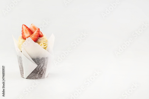 Cupcake with strawberries on a white background with space for writing text.