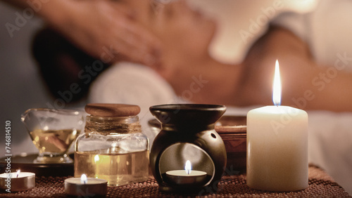 Perfect evening. Woman enjoying face massage and aroma spa