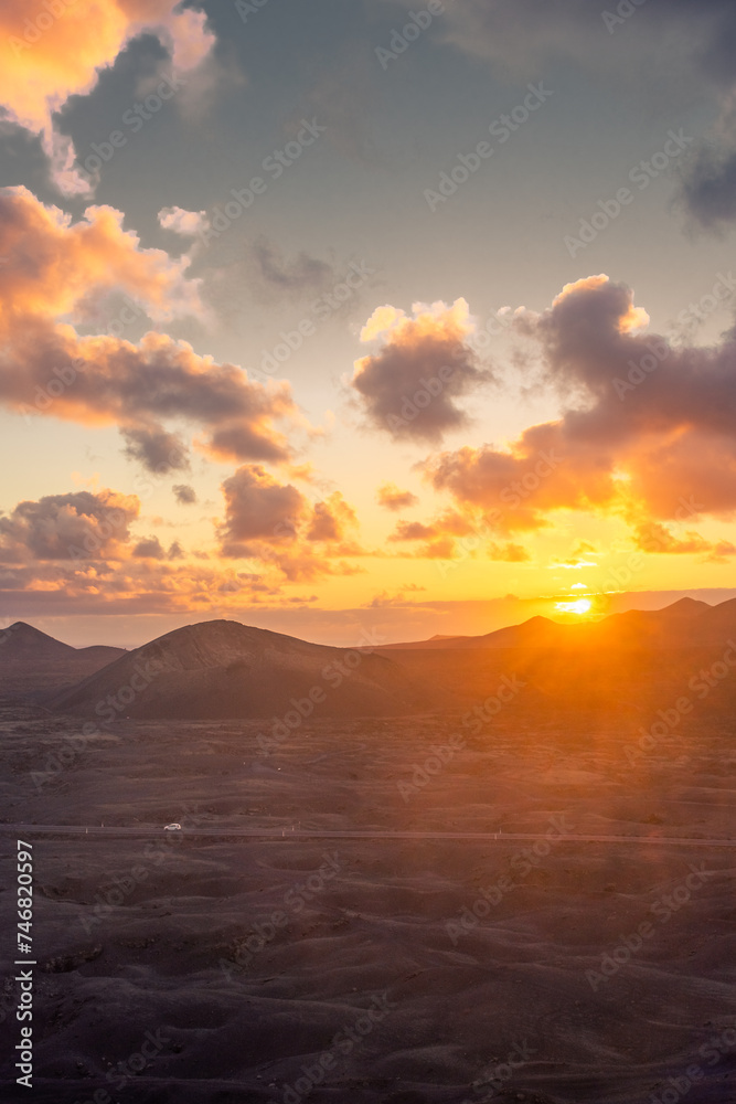Amazing sunset over El Cuervo Volcano, in Lanzarote, Canary Islands,  Spain - obrazy, fototapety, plakaty 
