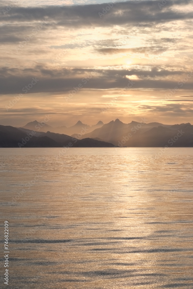 Gorgeous light of sunset behind mountains of East Greenland