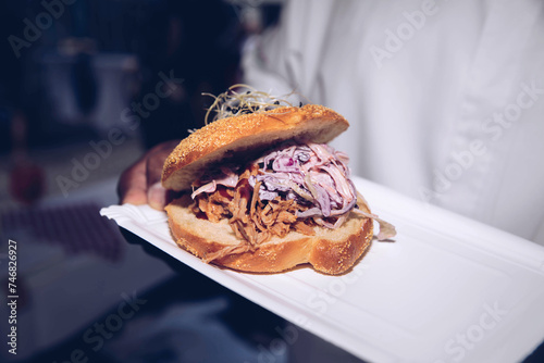 Finished Pulled Pork Sandwich Topped with Coleslaw on Plate
