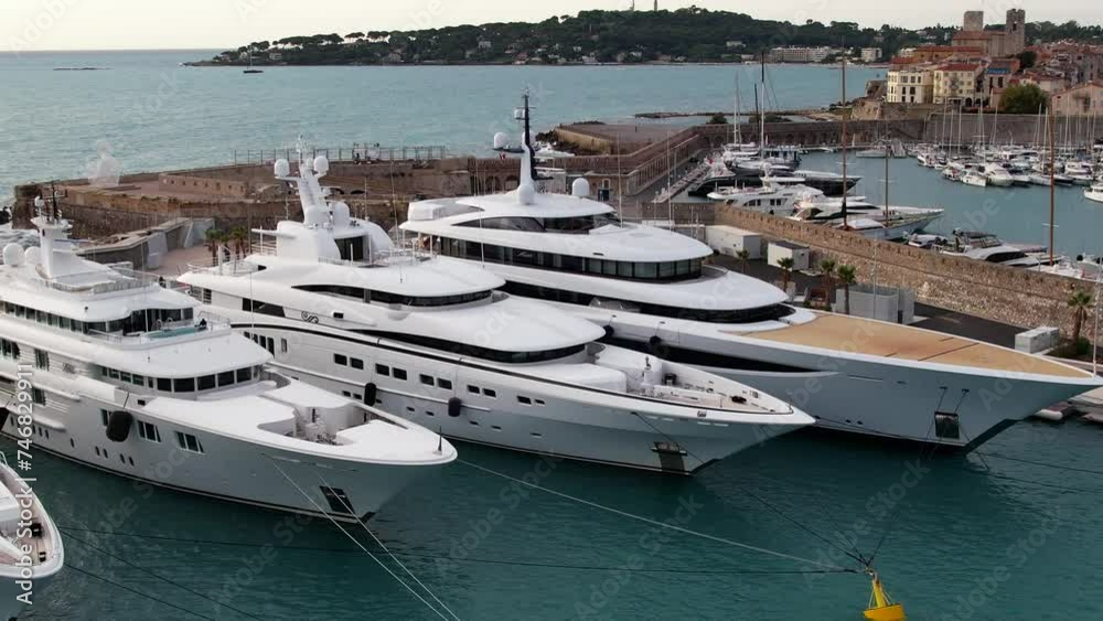 Super Mega Yachts in the French Riviera in the port of Antibes - Aerial sunrise flyover Super Mega Yachts in the French Riviera in the port of Antibes - Aerial sunrise flyover