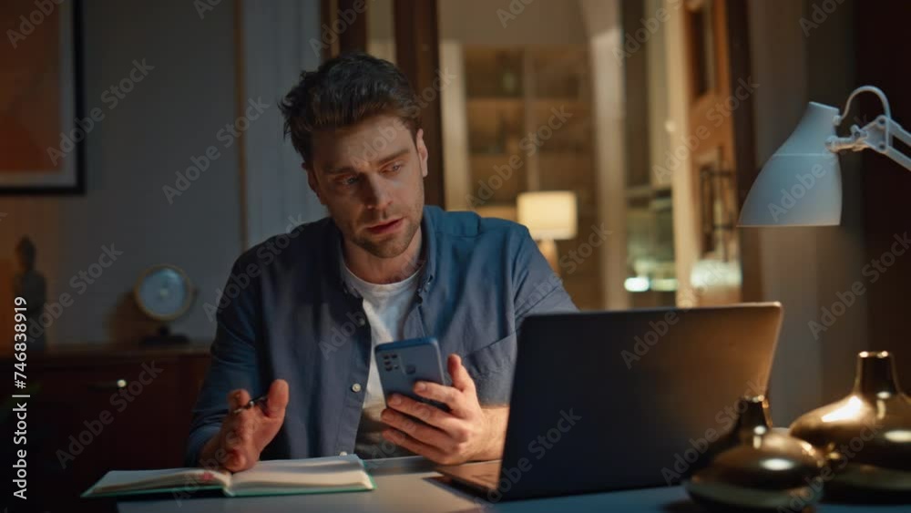 Online manager writing notes at late home closeup. Calm man videocalling laptop Online manager writing notes at late home closeup. Calm man videocalling laptop