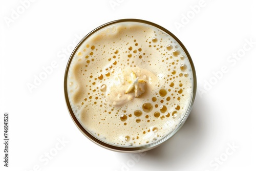 Delicious vanilla milkshake in glass on white background top view