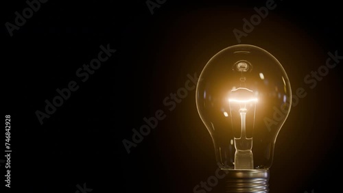 Bulb Light Turn On and Glow. An abstract animation of a bulb light turning on and glowing. Depicting idea, creativity, knowledge and abstract concepts. photo