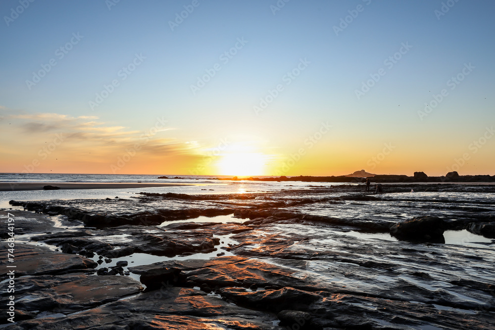 Sunset above rocks and tide pools on the Oregon Coast in Lincoln City at Roads End. Glistening water, rock formations and soft sunshine. Sunset above rocks and tide pools on the Oregon Coast in Lincoln City at Roads End. Glistening water, rock formations and soft sunshine.