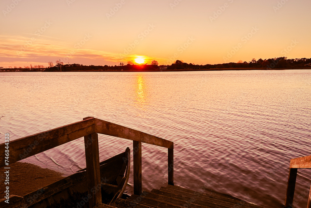 Azurreira, Ovar, Portugal. Wide view of the natural scenery of sunset over the water in Ria de Aveiro.