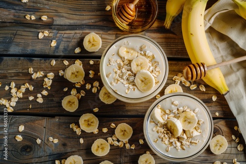 Top view of a vegetarian banana smoothie with oat flakes yogurt and honey on a wooden table