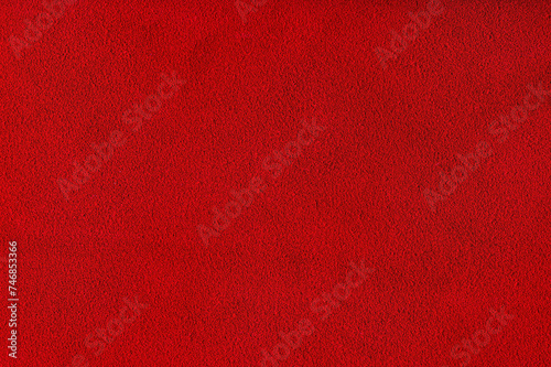 Red velvet background studio photo. Macro photo of natural red-dyed suede.