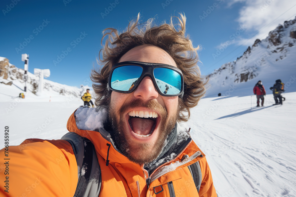 Excited skier taking selfie on snowy mountain slopes