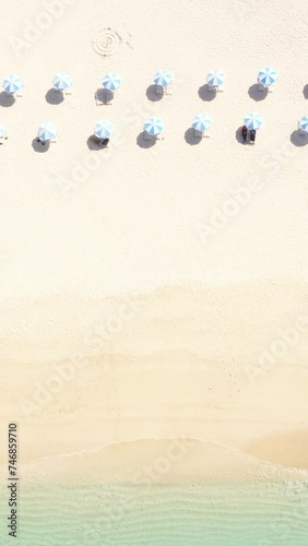 Vertical video 4K Emerald blue Okinawa coast and blue parasols