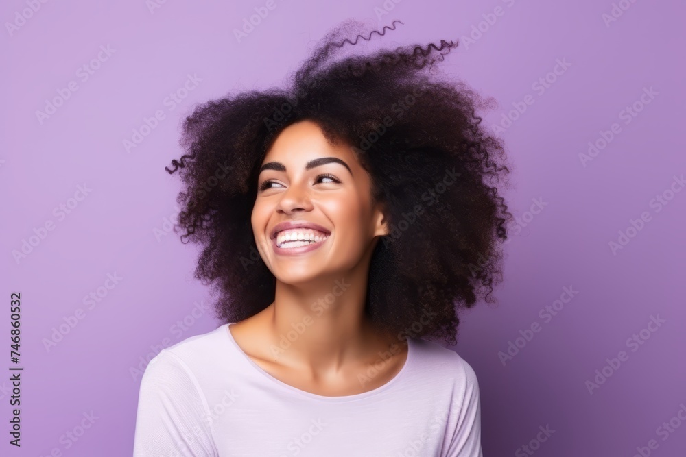 Portrait of a beautiful young african american woman smiling against purple background Portrait of a beautiful young african american woman smiling against purple background