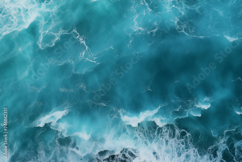 Drone aerial footage of electric blue ocean with wind waves crashing on the shore, a breathtaking aerial view photo