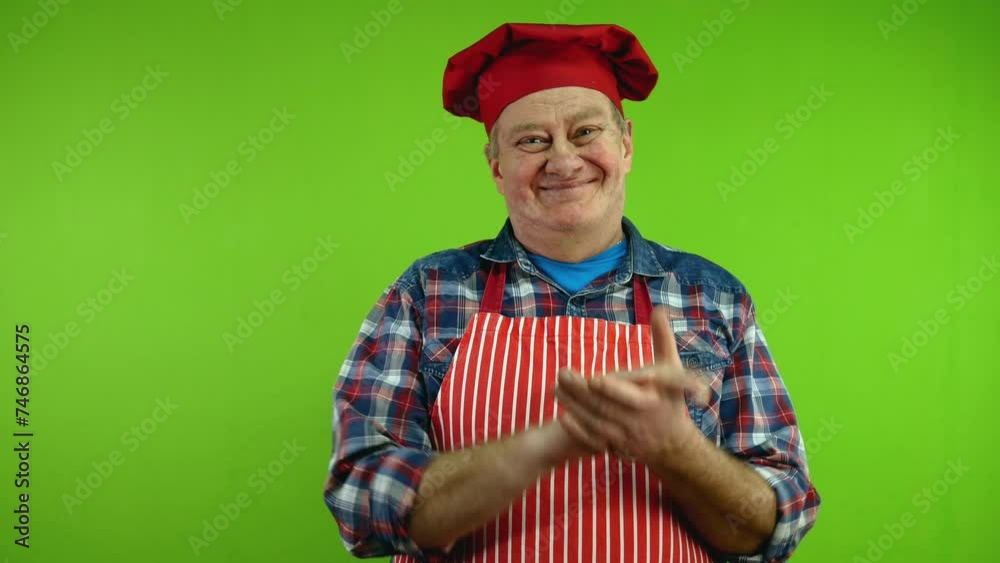 Senior chef in red apron applauding and expressing admiration. Senior chef in red apron applauding and expressing admiration.