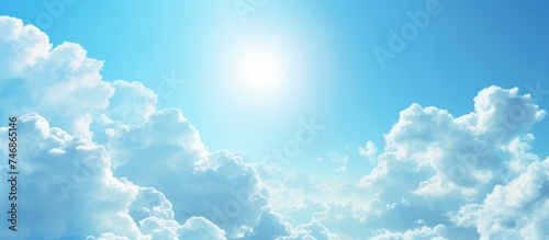 Serene Blue Sky with Fluffy White Clouds and Radiant Sun Above
