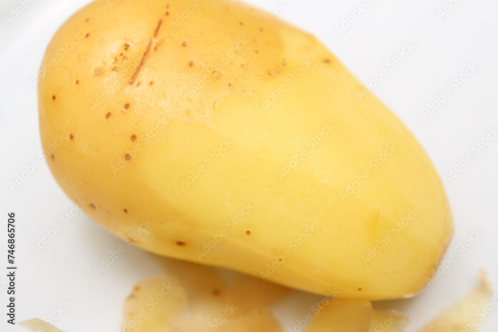 potato with skin and without skin. half peeled potato. potato details.