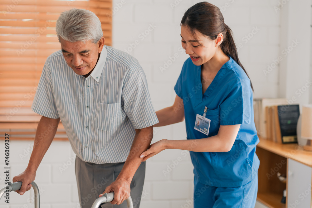 Obraz premium Asian physiotherapist nursing home to support old senior man patient therapy by walker, caregiver nurse help recovery health care with elderly retirement man person at home, health insurance concept
