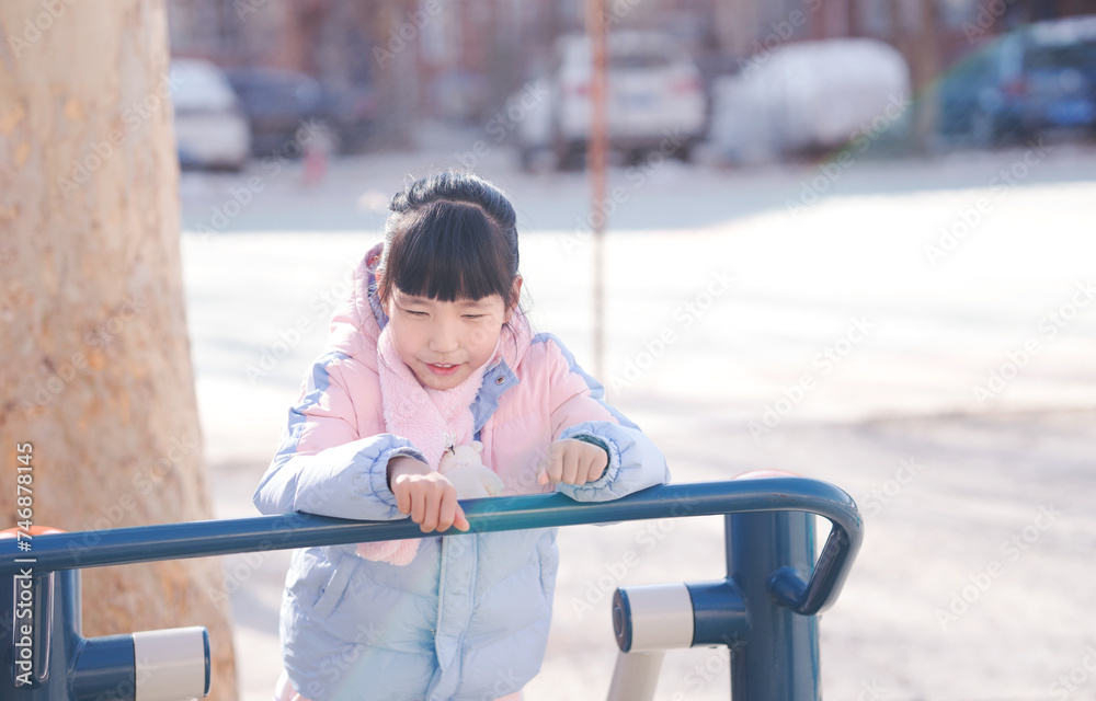A little girl playing happily in the park A little girl playing happily in the park
