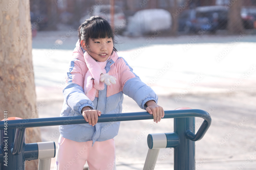A little girl playing happily in the park A little girl playing happily in the park