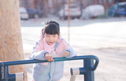 A little girl playing happily in the park