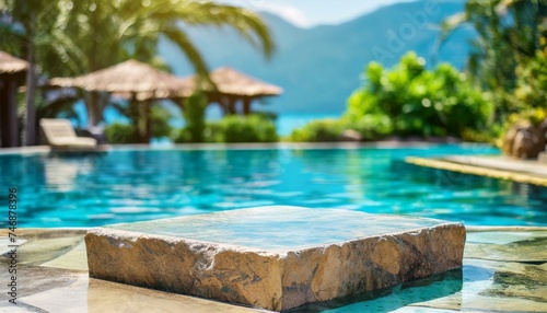 Stone podium stand in luxury blue pool water. Summer background of tropical design product placement display. Hotel resort poolside backdrop.  